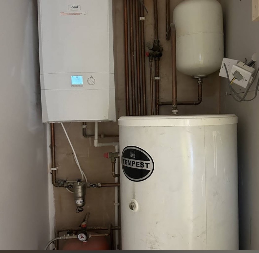 Ideal system boiler installed alongside an unvented hot water cylinder and expansion vessel.